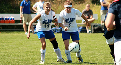 Two Wilson Phoenix soccer players in action during a game.